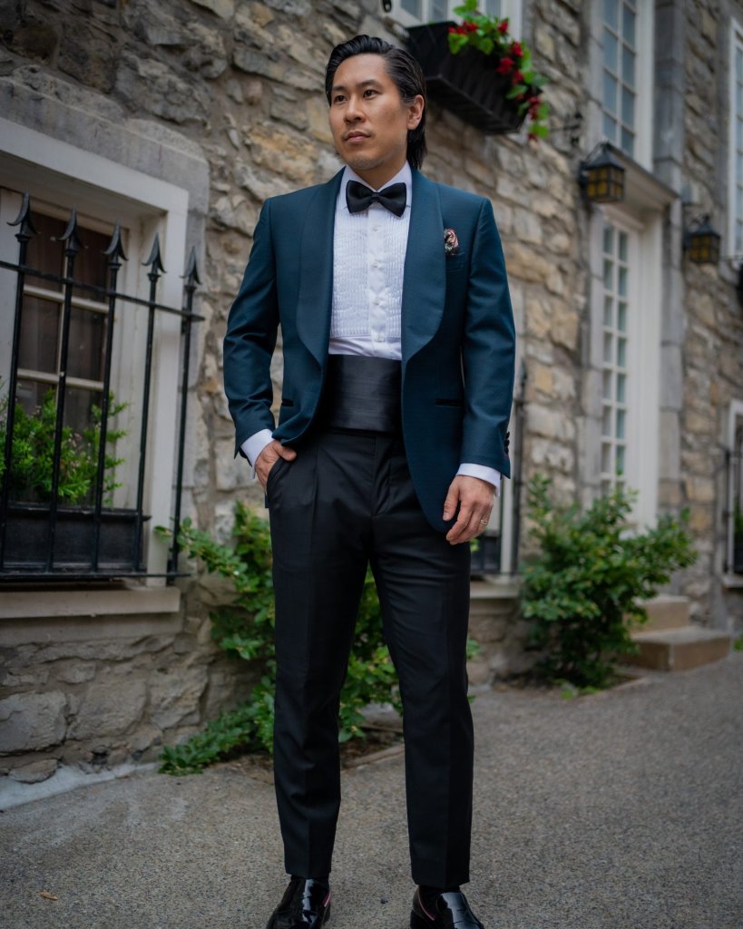 an elegant navy tuxedo with a black bow tie and a shirt with black buttons  looks amazing and bright